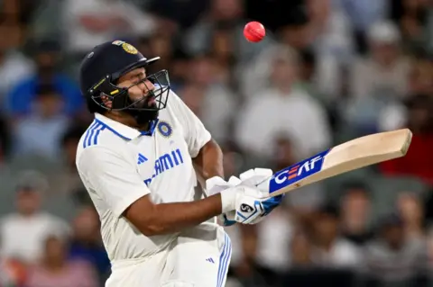 AFP Indian batsman Rohit Sharma is injured by the ball during the second day of the second Test cricket match between Australia and India at the Adelaide Oval in Adelaide on December 7, 2024.