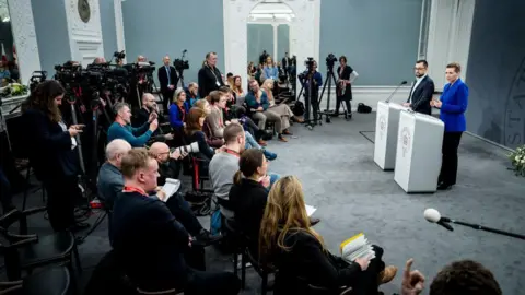 Getty Images Danish Prime Minister Mette Frederiksen and Greenland's Nalakkerswiss Chairman Mute B. Agede hold a press conference in Copenhagen.