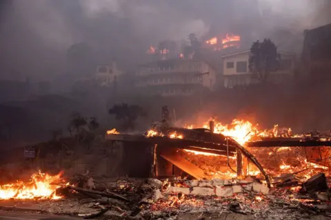 Getty Images A photo showing beach and hillside homes in Malibu, California, as the Palisades fire burns, Wednesday, Jan. 8, 2025.