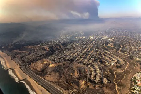 Robert Gauthier/Los Angeles Times Aerial view of a neighborhood destroyed by the Palisades fire via Getty Images