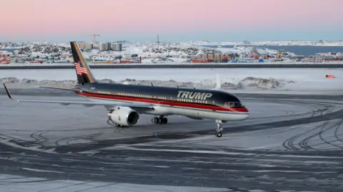 Reuters A plane with the words 'Trump' next to snow and ice on the tarmac at an airport in Greenland.